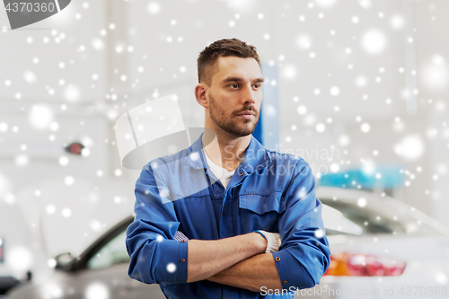 Image of happy auto mechanic man or smith at car workshop