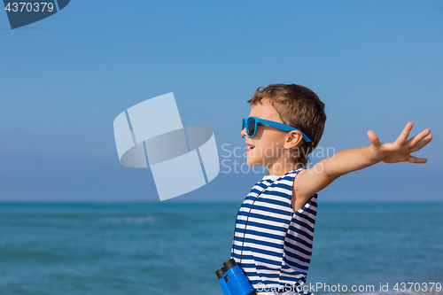 Image of One happy little boy playing on the beach at the day time