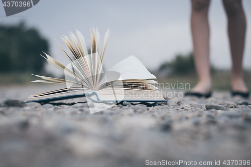 Image of open book lying on the road.