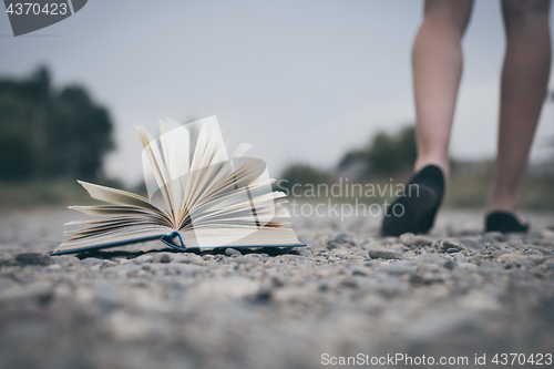 Image of open book lying on the road