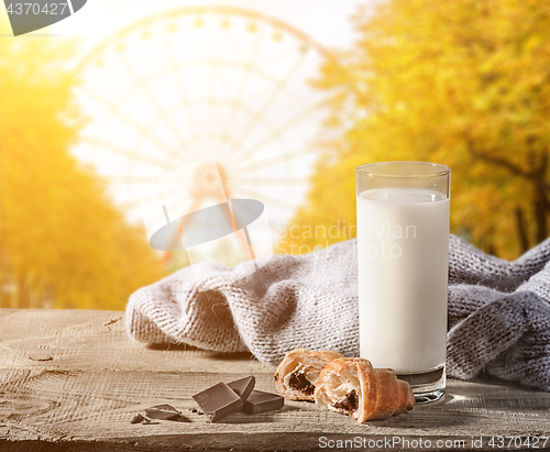 Image of Milk with a croissant on a wooden table