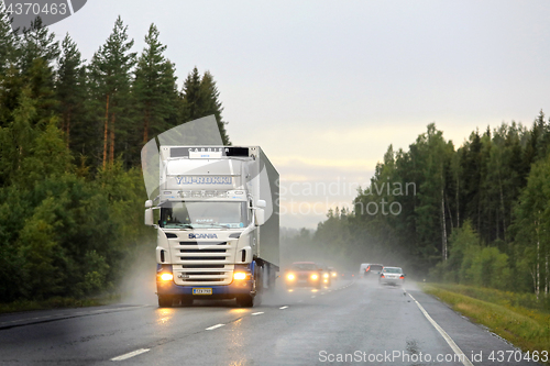 Image of White Scania Trucking on Rainy Highway