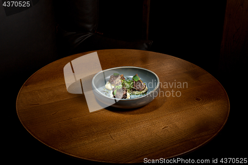 Image of Grilled steak with vegetables puree on plate.