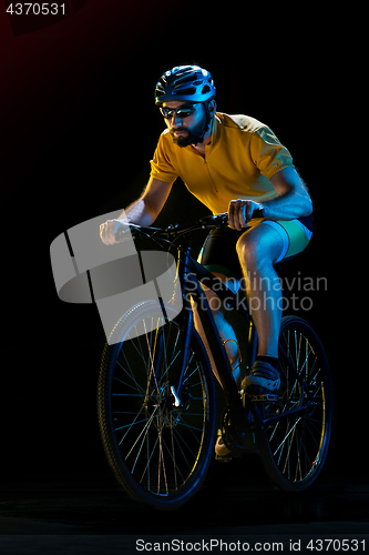 Image of The bicyclist on black, studio shot.