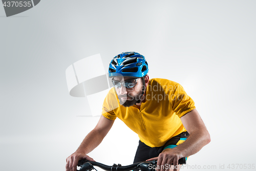 Image of The bicyclist on gray, studio shot.