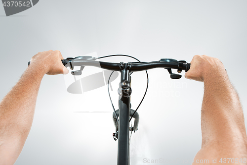 Image of The bicyclist on gray, studio shot.