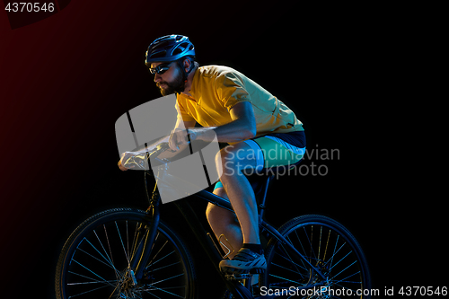 Image of The bicyclist on black, studio shot.