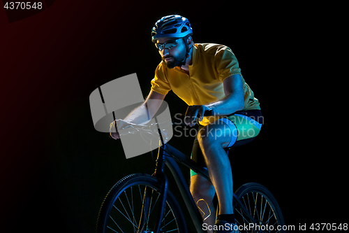 Image of The bicyclist on black, studio shot.