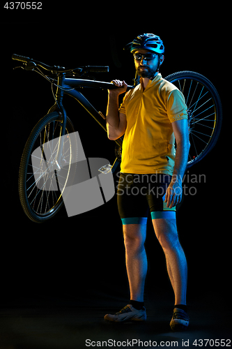 Image of The bicyclist on black, studio shot.