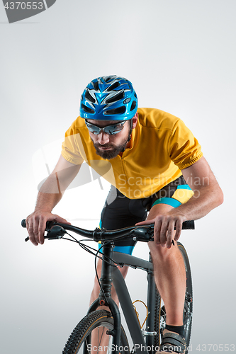 Image of The bicyclist on gray, studio shot.