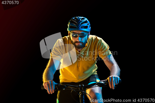 Image of The bicyclist on black, studio shot.