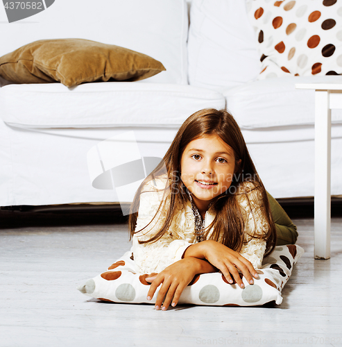 Image of little cute brunette girl at home interior happy smiling close u