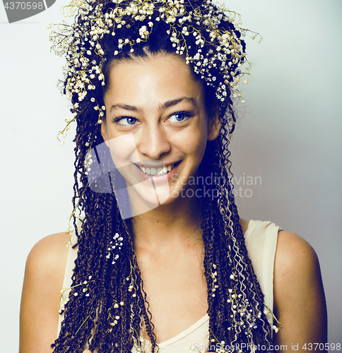 Image of young pretty brunette girl with bouquet of little white spring f