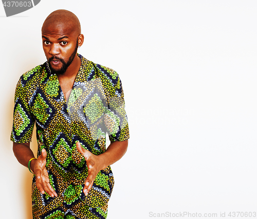 Image of portrait of young handsome african man wearing bright green national costume smiling gesturing, entertainment stuff 