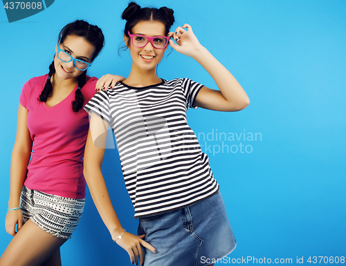 Image of best friends teenage school girls together having fun, posing emotional on blue background, besties happy smiling, lifestyle people concept 
