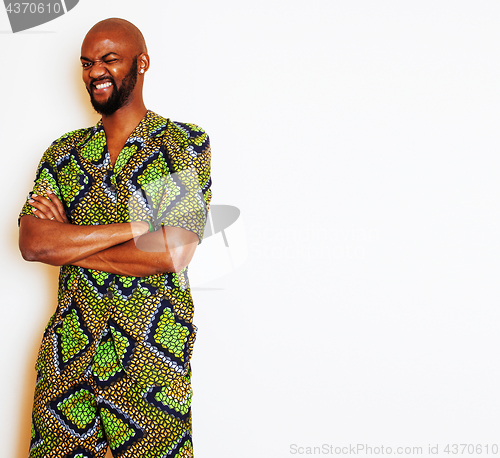 Image of portrait of young handsome african man wearing bright green national costume smiling gesturing, entertainment stuff 