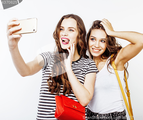 Image of best friends teenage girls together having fun, posing emotional on white background, besties happy smiling, lifestyle people concept close up. making selfie