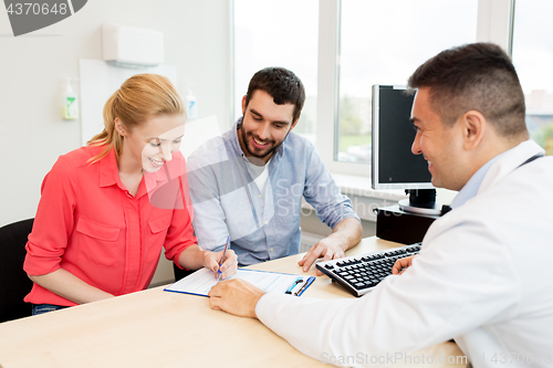 Image of couple visiting doctor at family planning clinic