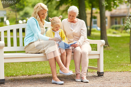 Image of woman with daughter and senior mother at park