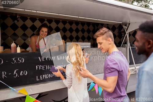 Image of happy customers queue at food truck