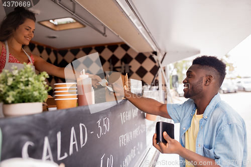 Image of african american man buying wok at food truck