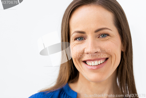 Image of face of happy smiling middle aged woman