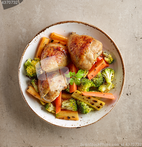 Image of Plate of grilled chicken legs and vegetables