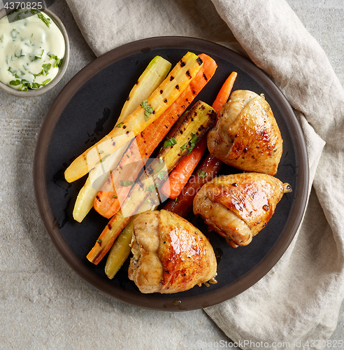 Image of plate of grilled chicken legs and carrots