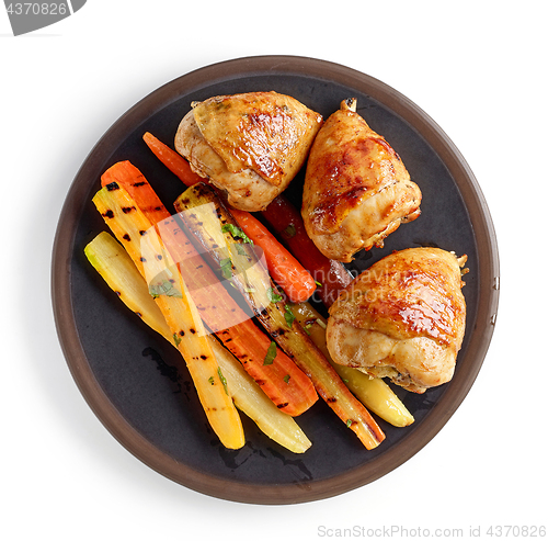 Image of plate of grilled chicken legs and carrots