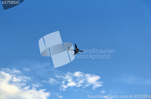 Image of Airplane in the blue sky with clouds