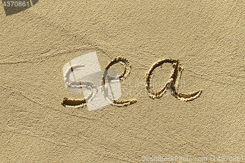 Image of Natural sand background with scrawled word ''Sea''