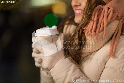 Image of happy woman with coffee over christmas lights