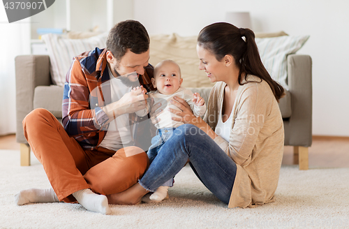 Image of happy family with baby having fun at home