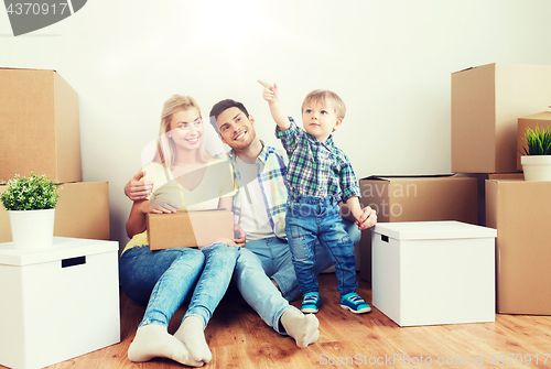 Image of happy family with boxes moving to new home