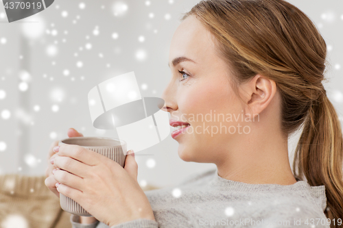 Image of happy woman with cup or mug drinking at home