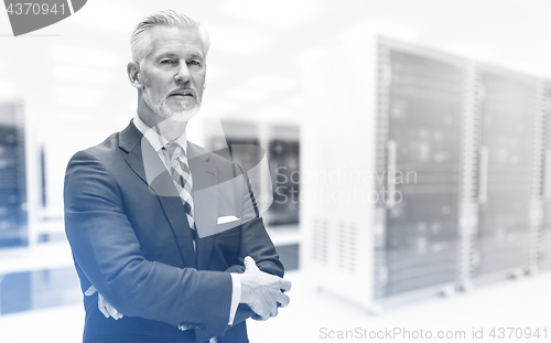 Image of Senior businessman in server room