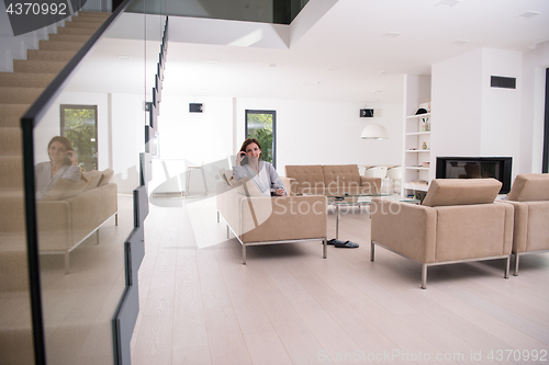 Image of young woman in a bathrobe enjoying morning coffee