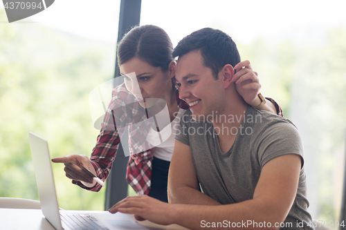 Image of happy young couple buying online