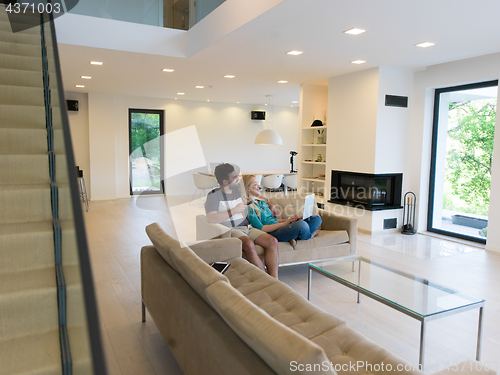 Image of young happy couple relaxes in the living room