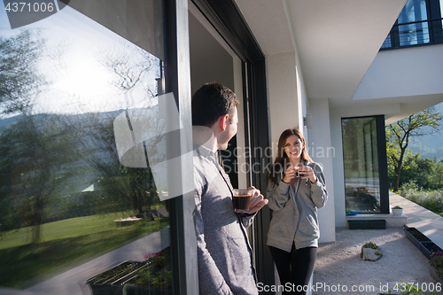 Image of couple enjoying on the door of their luxury home villa