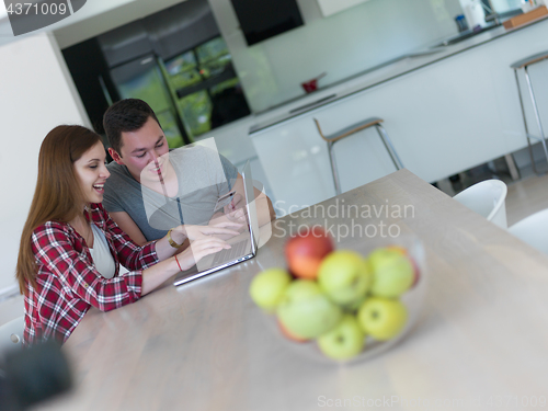 Image of happy young couple buying online