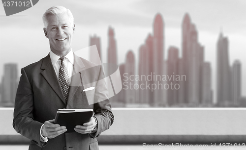 Image of Senior businessman in front of the big city