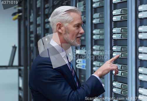 Image of Senior businessman in server room