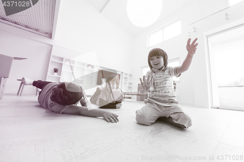 Image of boys having fun with an apple on the floor