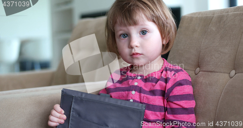 Image of Child using tablet in modern apartment