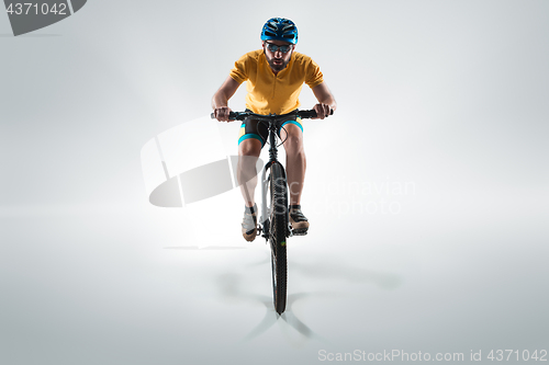 Image of The bicyclist on gray, studio shot.