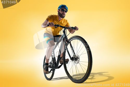 Image of The bicyclist on gray, studio shot.