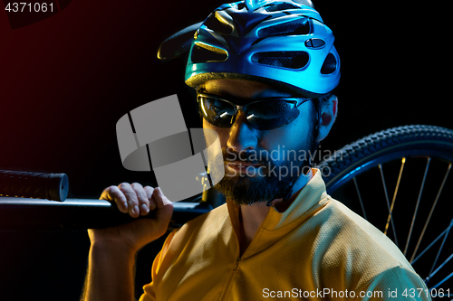 Image of The bicyclist on black, studio shot.