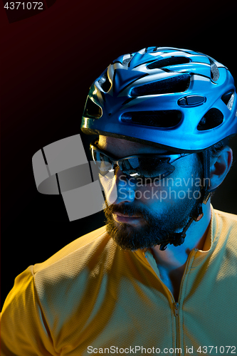 Image of The bicyclist on black, studio shot.