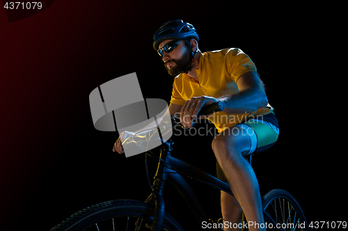 Image of The bicyclist on black, studio shot.